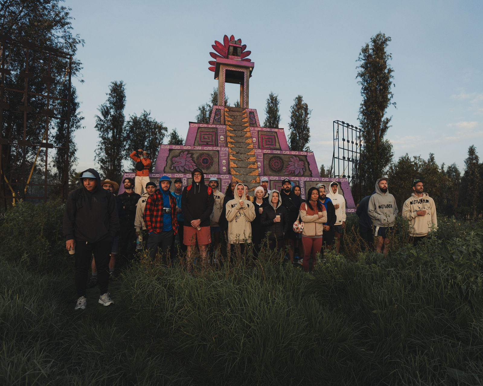 The crew gathered by a colorful pyramid